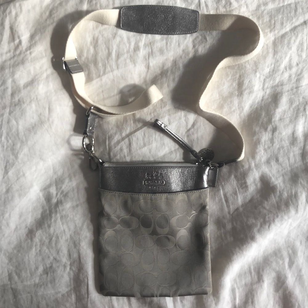 Coach cross body purse in silver logo print. Like new (one scratch on back)